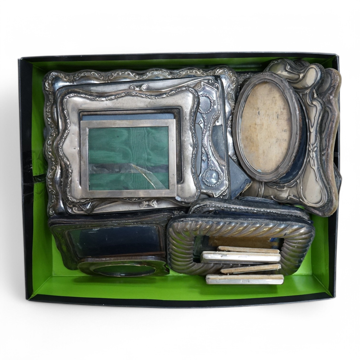 A George V plain silver mounted rectangular photograph frame by Asprey & Co, London, 1910, 12.4cm by 10cm, one other George V silver mounted oval photograph frame and fifteen other assorted modern silver mounted photogra